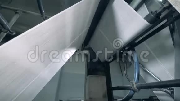 纸卷正在通过印刷机移动在工厂里印刷报纸视频的预览图