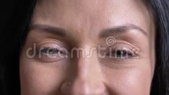 一张美丽的白种人成年女性脸的特写照片灰色的眼睛看着镜头脸上带着微笑和蔼的表情视频的预览图