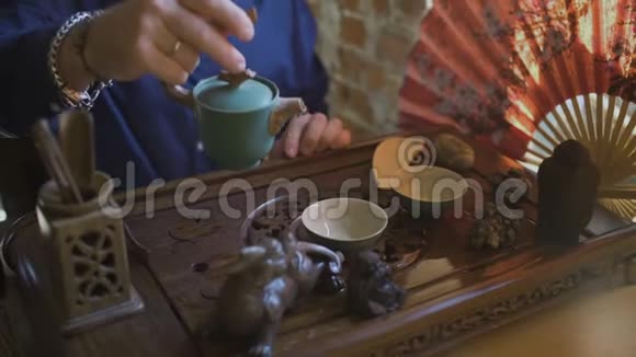 在中国传统茶道中人从茶壶到盖湾倒绿茶的幻灯片视频的预览图