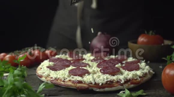 在意大利辣香肠比萨饼上涂上帕尔马干酪视频的预览图