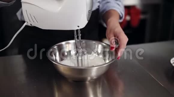 在碗中加入搅拌机烘焙蛋糕甜点的搅拌过程中将蛋奶油加入到碗中现代工作室视频的预览图