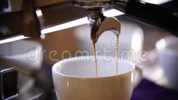 咖啡师做咖啡一杯浓咖啡倒在白色的杯子里视频的预览图