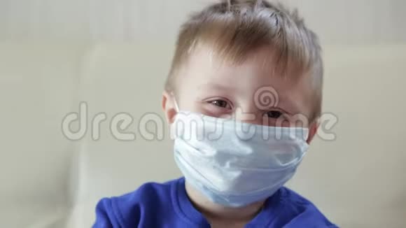 一个带面具的男孩的特写戴着医用面具的婴儿微笑着视频的预览图