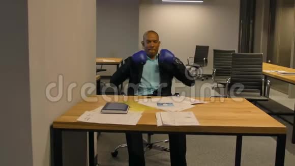 办公室里戴拳击手套的非裔美国商人视频的预览图