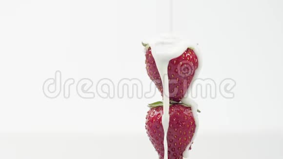 新鲜健康食品草莓和酸奶一起倒酸奶和鲜奶油中的浆果鲜果加鲜奶油视频的预览图