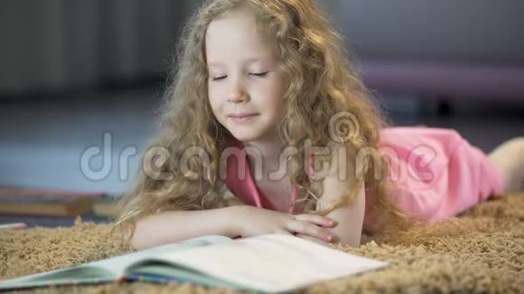 聪明的女孩翻书页阅读有趣的文学作品教育视频的预览图
