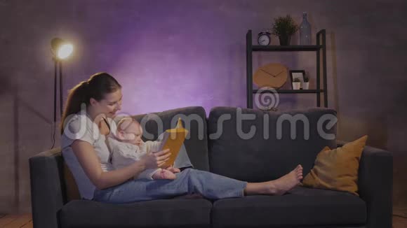一个女人在一个舒适的公寓里和她的孩子在沙发上玩耍妈妈和宝贝都很开心视频的预览图