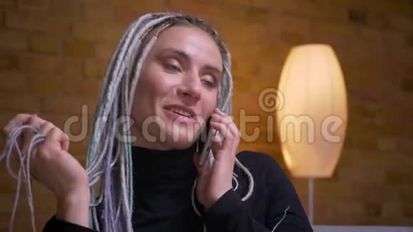 一位年轻迷人的白种人女性金发的可怕的金发女郎在打电话时她开心地微笑着视频的预览图