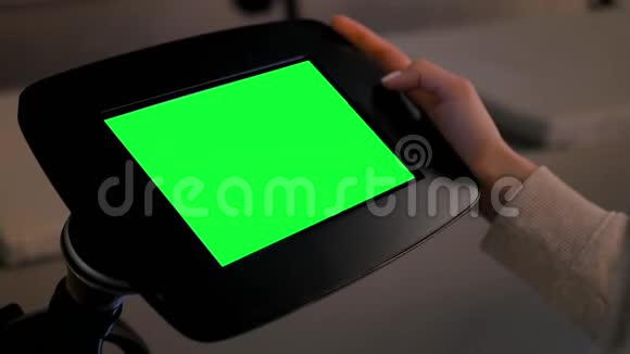 绿色屏幕概念女人看展示地面站立的平板电脑亭视频的预览图