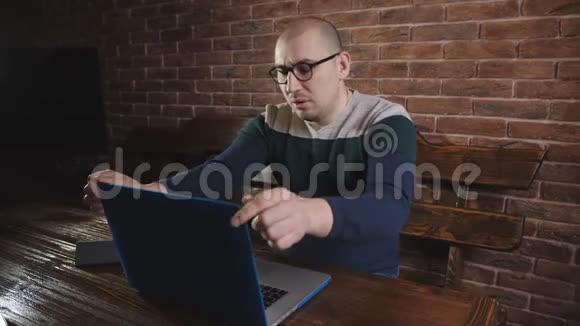 在笔记本电脑上工作的疲惫的人关上笔记本电脑摘下眼镜视频的预览图