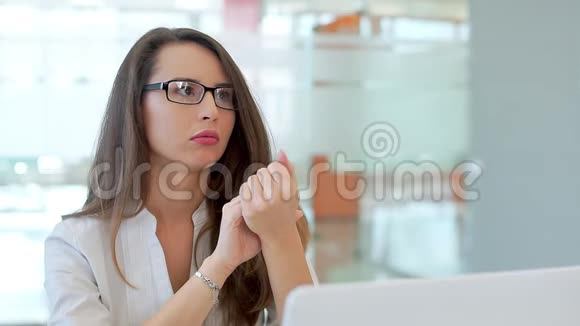 办公室里的那个女孩坐在他的办公桌前和一名雇员交谈视频的预览图