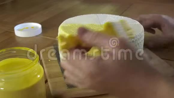 奶酪制造商用液体乳胶的黄色保护涂层覆盖白色奶酪头视频的预览图