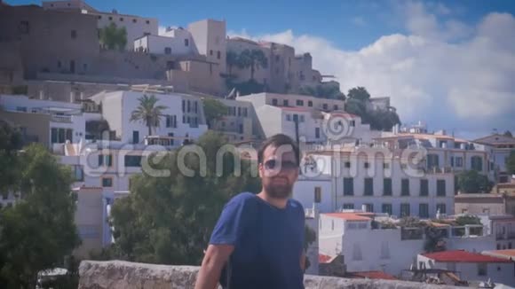 在伊比萨镇的达尔特维拉戴着甜眼镜的英俊青年微笑着Eivissa老城视频的预览图