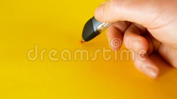 一个男人用3d打印机笔在黄色背景下画画这是创新技术等主题的理想画面视频的预览图