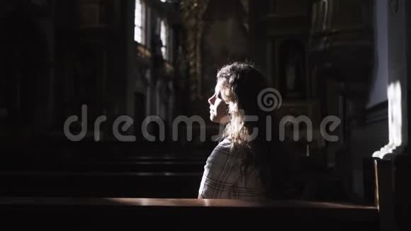 坐在黑暗大教堂里的女人视频的预览图