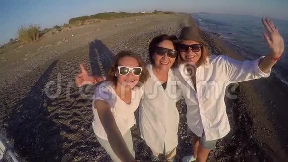 妈妈带着两个成年女儿在海滩上自拍视频的预览图