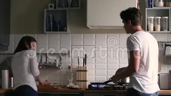 有趣的千禧夫妇在厨房一起做饭时跳舞视频的预览图