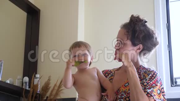注意牙齿背景母亲背景妈妈和孩子在浴室刷牙幸福家庭概念视频的预览图