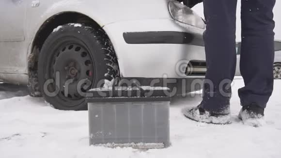 一个人修理一辆车冬天冷启动电池变弱慢动作视频的预览图