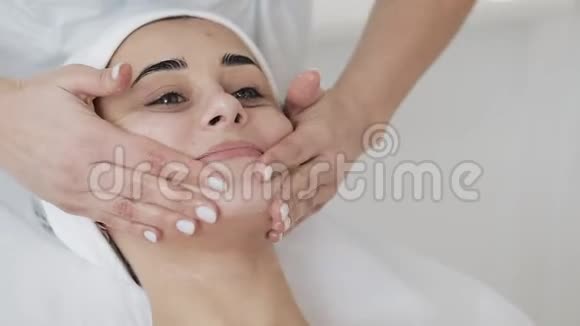 清洁泡沫年轻漂亮的女人在拜访美容师的时候有一个泡沫清洗程序慢动作视频的预览图