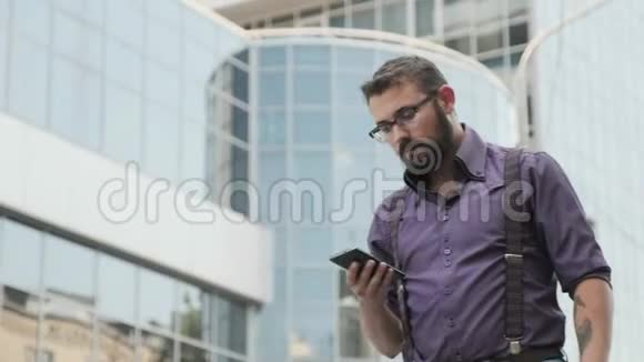 一个长相严肃的男人正在走着打电话视频的预览图