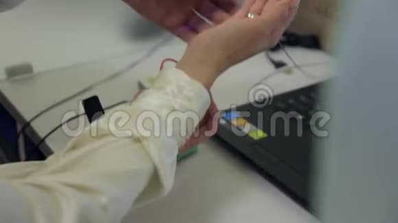 一位男性医生将病人连接到用于健康研究的创新电子设备的手中新医疗视频的预览图