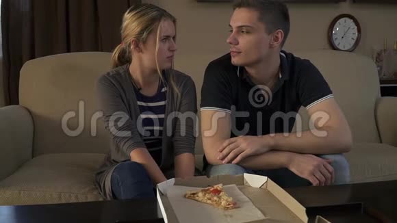 可爱的年轻夫妇坐在靠近披萨的弗沃德沙发上视频的预览图