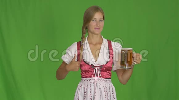 德国传统服装上的漂亮女孩绿色啤酒上的啤酒视频的预览图