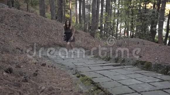 小女孩爬上森林走得很累喝水视频的预览图