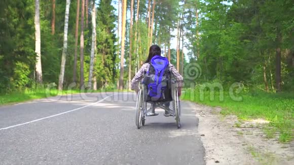 坐轮椅的残疾女孩骑在高速公路上慢节奏视频的预览图