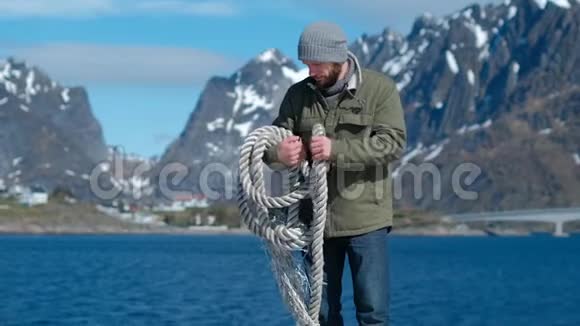 勇敢的人肩上有一根绳子系在群山和蓝天的背景上视频的预览图