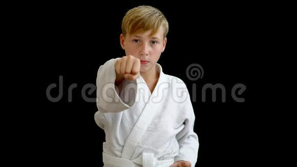一位穿着白色和服的年轻运动员用右手打拳男孩用一只手臂环住腰部视频的预览图