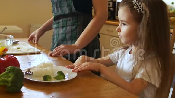 女孩果断地推开了一盘食物看着母亲摇摇头孩子拒绝吃东西视频的预览图