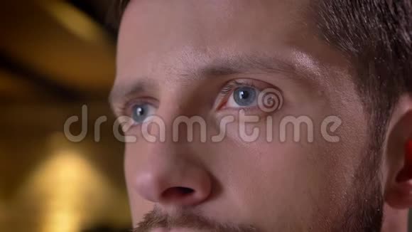 一张年轻的白种人男性脸上蓝眼睛向前看的特写照片视频的预览图