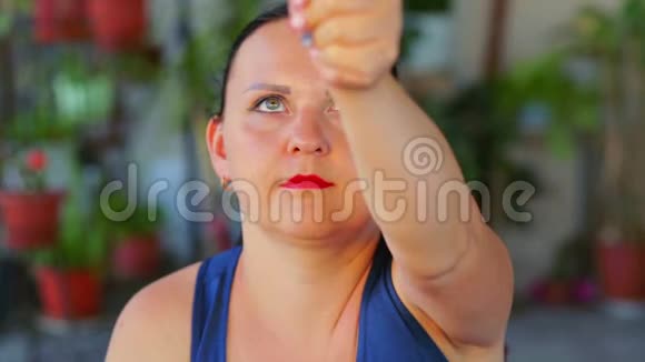 一个年轻的女人做一个运动的眼睛同时看一个手指并推迟它视频的预览图