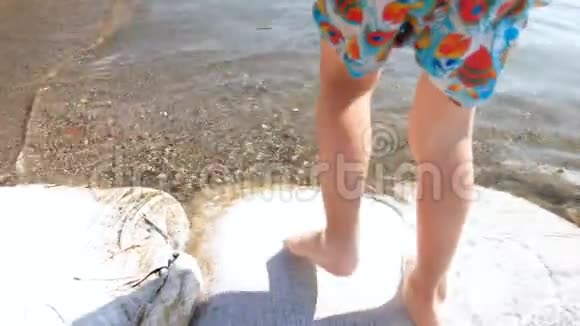 特写4k小男孩在沙滩上海边散步的镜头视频的预览图