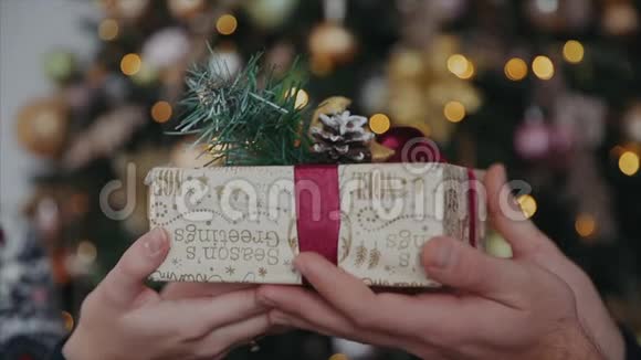 一对夫妇一起拿着圣诞礼物男性手把礼物送给女性视频的预览图