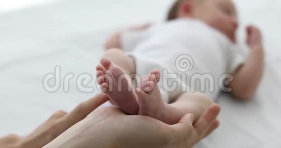 双手抚摸婴儿的脚视频的预览图
