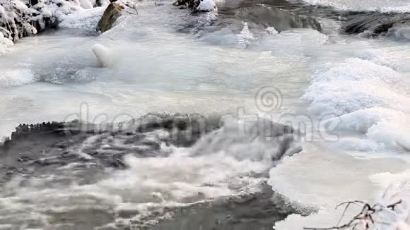 冬天带瀑布和冰柱的冰冻溪流视频的预览图