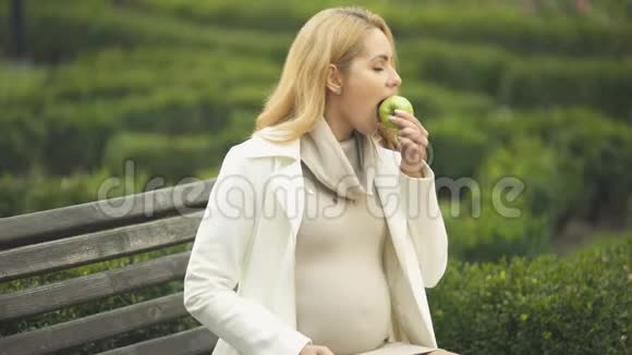 幸福期待女人咬绿苹果抚摸肚皮产妇保健视频的预览图