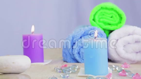 提供用于治疗和放松的蜡烛毛巾和石头的水疗沙龙桌视频的预览图
