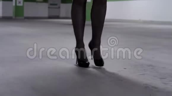 走路的女人穿着黑色长袜和高跟鞋的腿视频的预览图