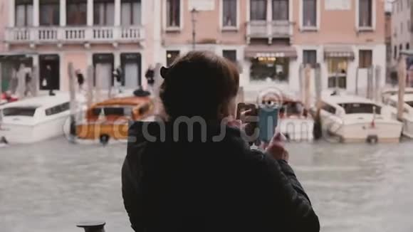 在威尼斯退休假期期间在一次贡多拉远足旅行中幸福的高级女性在拍摄智能手机照片视频的预览图