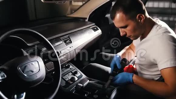 汽车服务一个年轻人用自动刷子打磨汽车面板视频的预览图