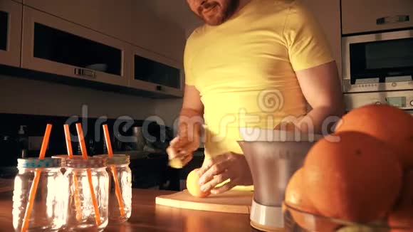 帅哥在家用榨汁机做新鲜橙汁视频的预览图