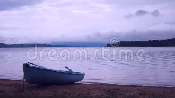 孤独的渔船停靠在平静的湖面上在水中铺盖或木制渔船视频的预览图