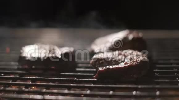 烤架上的肉排很多火最慢的动作火煮肉排和煤炭特写视频的预览图