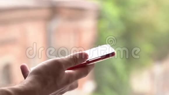 年轻的白种人大人手里拿着智能手机用手指敲着短信视频的预览图