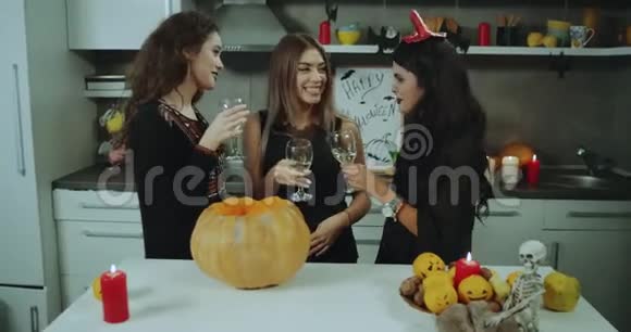 万圣节之夜年轻的女士们聚在一起在家里聚会喝酒微笑令人惊叹的装饰品视频的预览图
