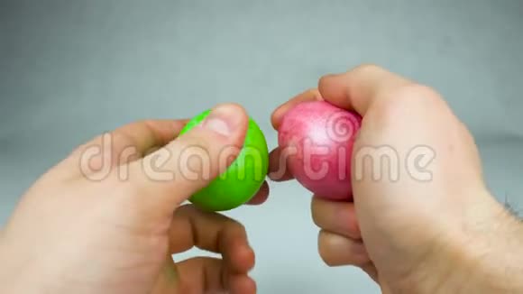 准备在基督教期间玩传统复活节游戏的人用彩色染色的彩蛋敲蛋或倾倒彩蛋视频的预览图